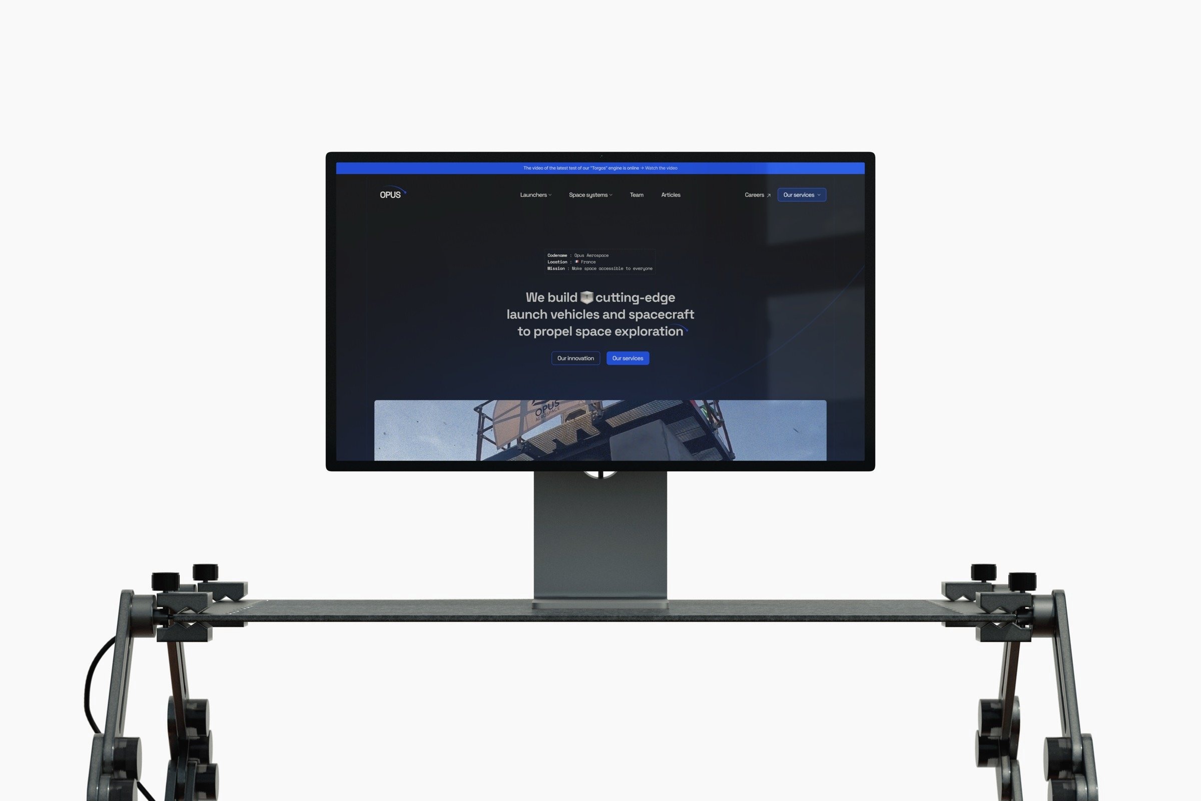 Opus Aerospace website shown on a display above a camera slider rig.